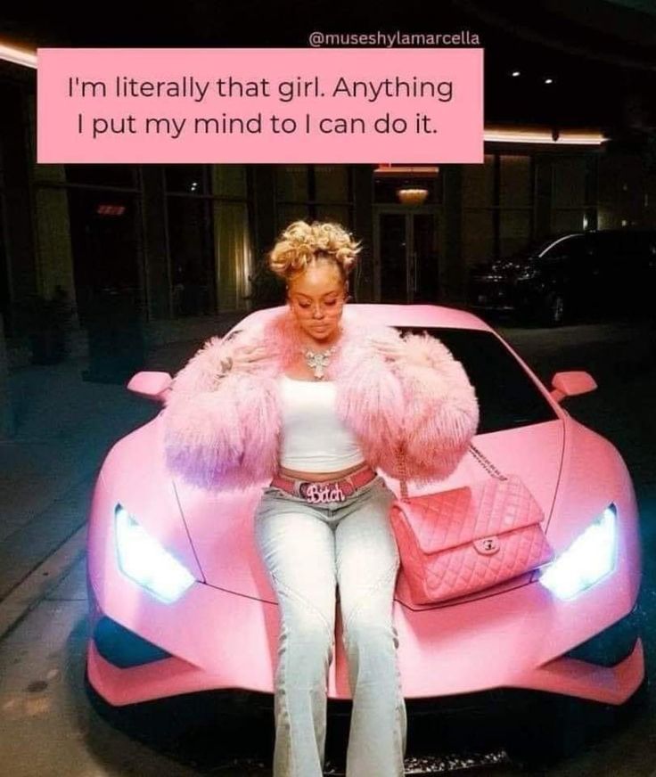 a woman sitting on top of a pink sports car