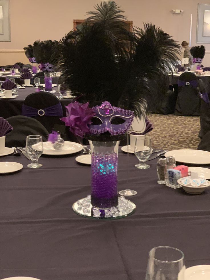 the table is set with purple and black decorations