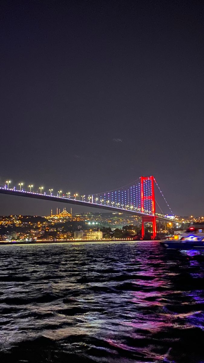 the bay bridge is lit up at night