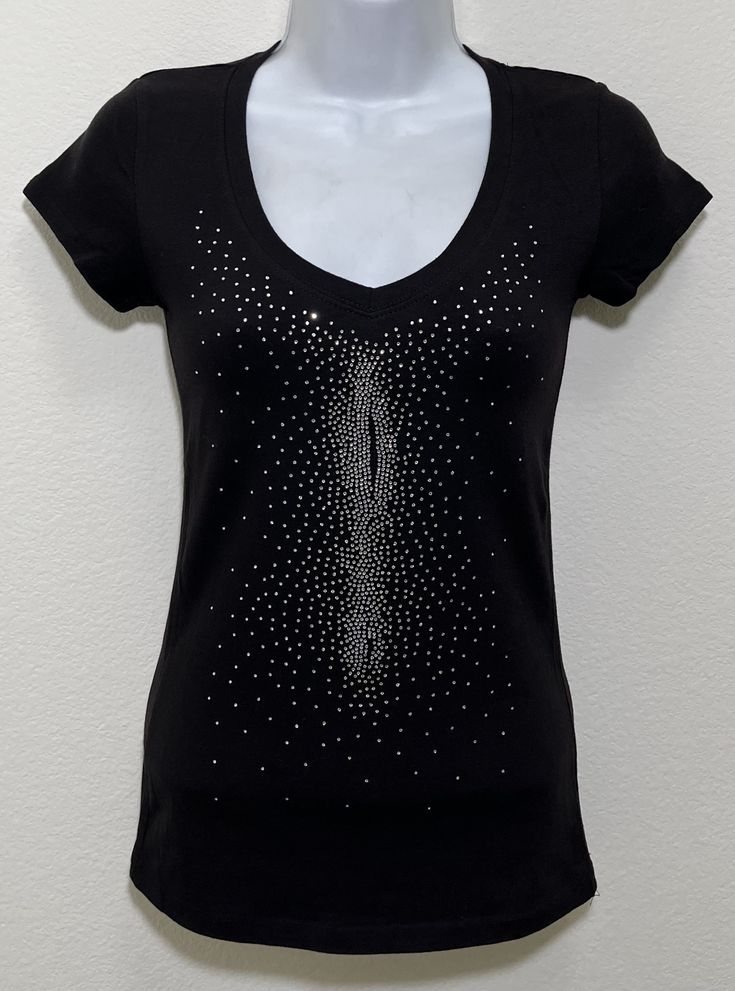 Fabric comprised of 95% cotton and 5% spandex.  Handmade rhinestone t-shirts made in the United States with quality rhinestones. Machine washable. T-shirt style is a fitted V-neck cap sleeve. Size Range:         XXS = 2         XS = 4         S = 6         M = 8         L = 10         XL = 12 Fitted Casual Tops With Rhinestones, Fitted Casual Top With Rhinestones, Casual Fitted Tops With Rhinestones, Casual Stretch Tops With Rhinestones, Cotton Tops With Rhinestones And Short Sleeves, Stretch Crew Neck Top With Rhinestones, Fitted Cotton Top With Rhinestones, Stretch Black Tops With Rhinestones, Cotton Short Sleeve Top With Rhinestones