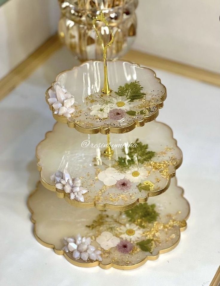 three tiered tray with flowers on it