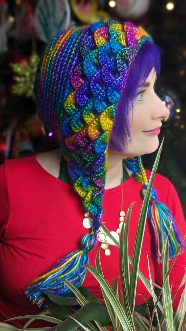 a woman with purple hair wearing a colorful hat