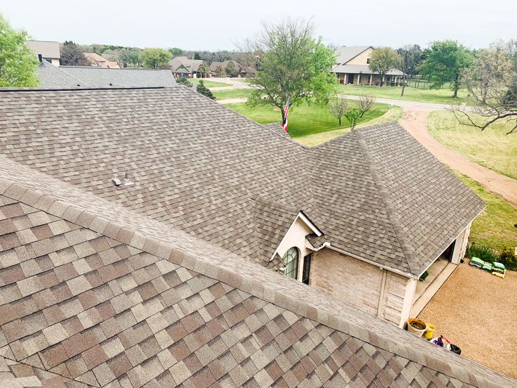 an aerial view of a house with brown shingles