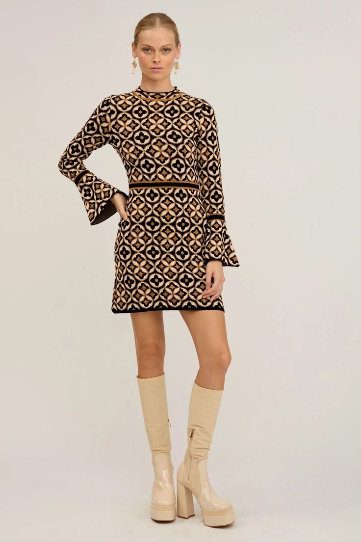 Get ready to make a statement with our Mitzy knit mini dress. With a nod to '60s mod style, this dress is designed from a structured knit fabric with a touch of gold woven throughout the amazing deco print. This dress is a true stand-out piece. Fit with long sleeves with flared edge for added flair this dress accentuat Skirt Model, Flare Sleeve Dress, Mod Style, Hippie Girl, 60s Mod, Mod Fashion, Mod Dress, Touch Of Gold, Knit Mini Dress