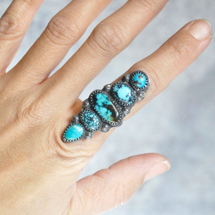 A statement ring of mixed turquoise. Sterling silver is patinaed for a weathered + antiqued look. Set in an hand forged bezel and a hand forged beaded band. D E T A I L S • Sterling Silver • 1.875"h x .75"w x .125"d • Size 7.25 US The ring will be carefully wrapped in tissue and placed in a decorative kraft box. It's ready to give to that special person! Rustic Hand Forged Ring Jewelry, Artisan Turquoise Ring With Patina, Rustic Turquoise Jewelry With Patina, Bohemian Hand Forged Turquoise Ring, Rustic Silver Rings With Patina, Handmade Rustic Silver Turquoise Ring, Turquoise Hand Forged Artisan Rings, Unique Turquoise Rings With Patina, Unique Hand Forged Turquoise Ring