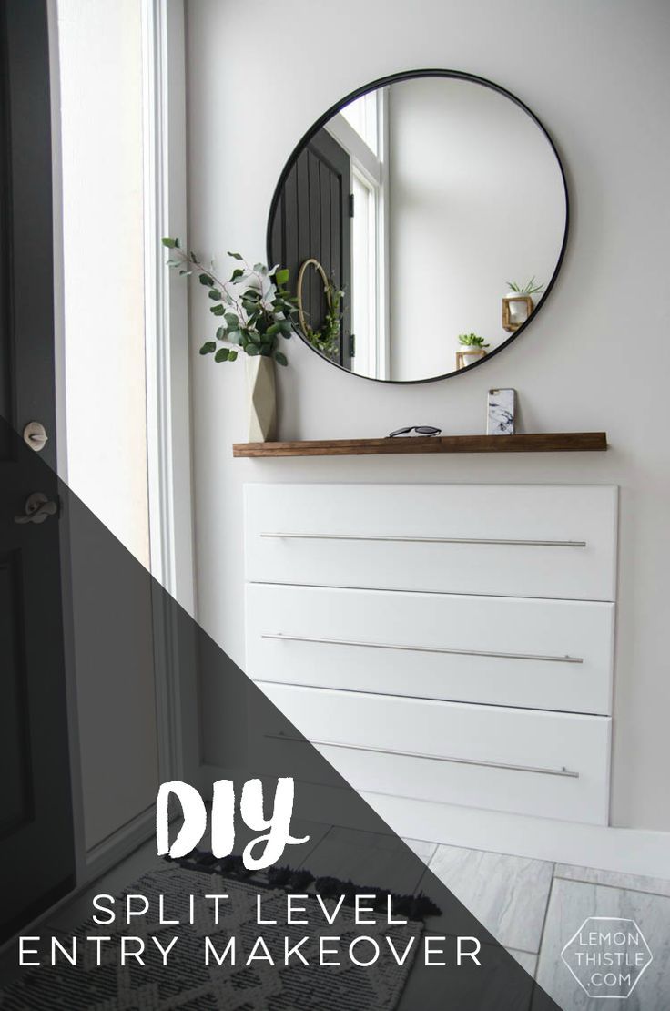 a white dresser with a round mirror above it and the words diy split level entry makeover