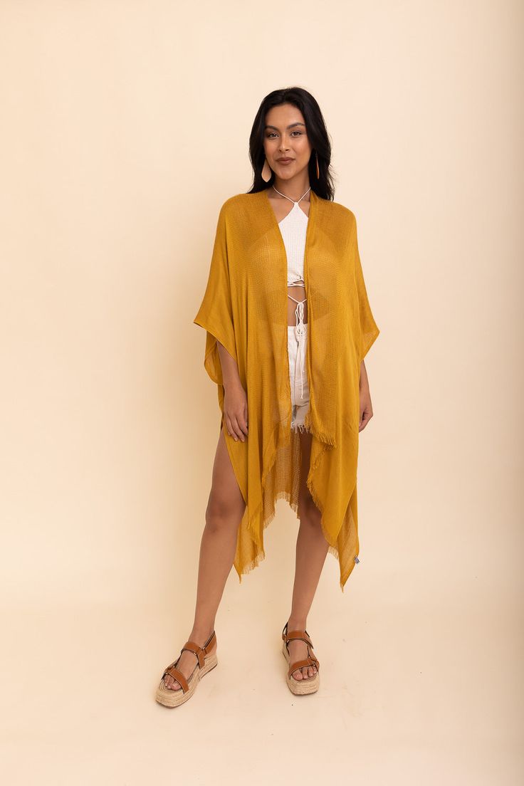 Flaunt your free-spirited style this summer with our Sun-kissed Breeze Frayed Trim Kimono! Perfect for vacations and weekend festivities, the kimono’s lightweight design is bound to keep you cool and comfortable. A layer of frayed trim along the borders adds an extra touch of texture and playfulness that is irresistible. The bright colors are bound to make you stand out so get ready to turn heads! Not only is it perfect for completing any beach-look, but also great to add a little extra flair to Lightweight Open Front Casual Cover-up, Breezy Wrap Cover-up For Vacation, Bohemian Lightweight Cover-up For Day Out, Chic Flowy Kimono For Beach Cover-up, Chic Summer Wrap Cover-up, Lightweight Cover-up For Beach Season, Lightweight Wrap Beach Cover-up, One Size Long Cover-up For Day Out, Chic Summer Cover-up With Relaxed Fit