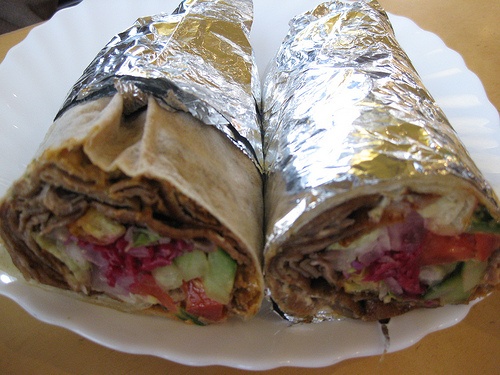 a wrap is cut in half on a plate