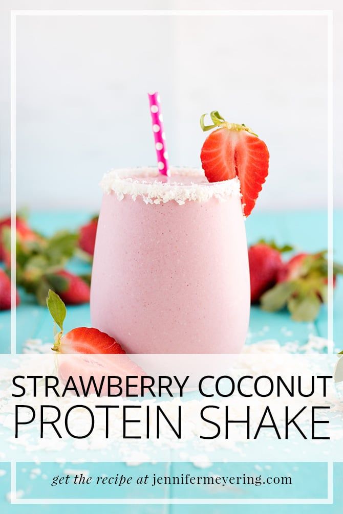 a smoothie with strawberries on the side and sprinkles around it