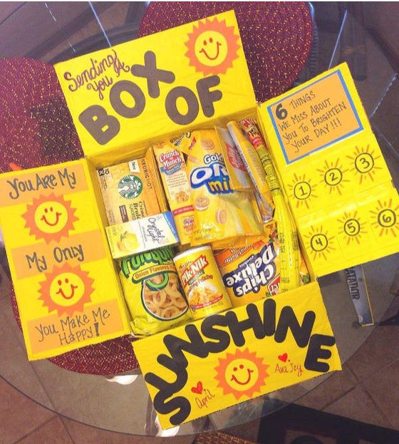 a box of sunshine snacks sitting on top of a glass table next to a sign