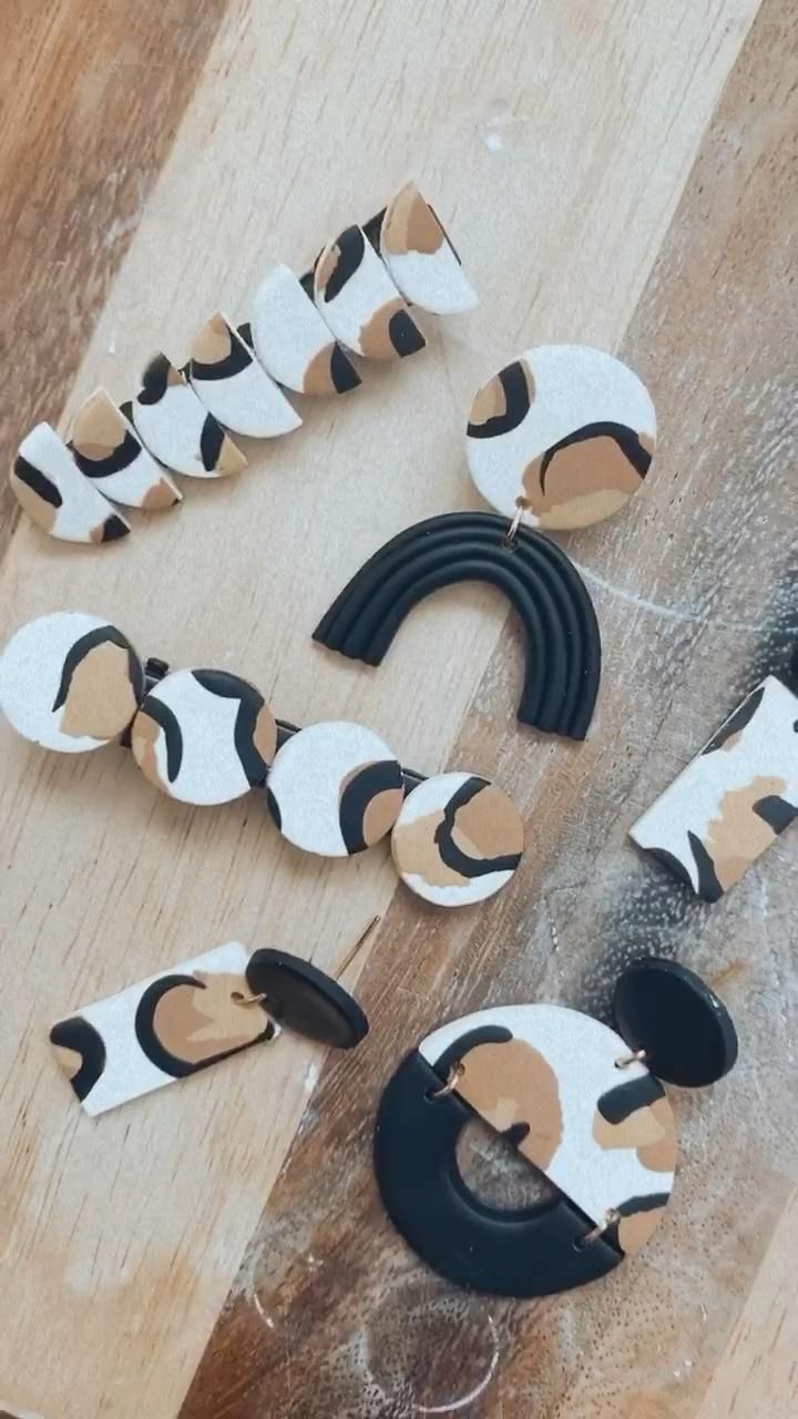 several pieces of paper cut out to look like cats and dogs on wooden boards with holes in them