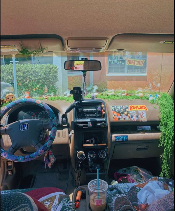 the interior of a car with various items in it