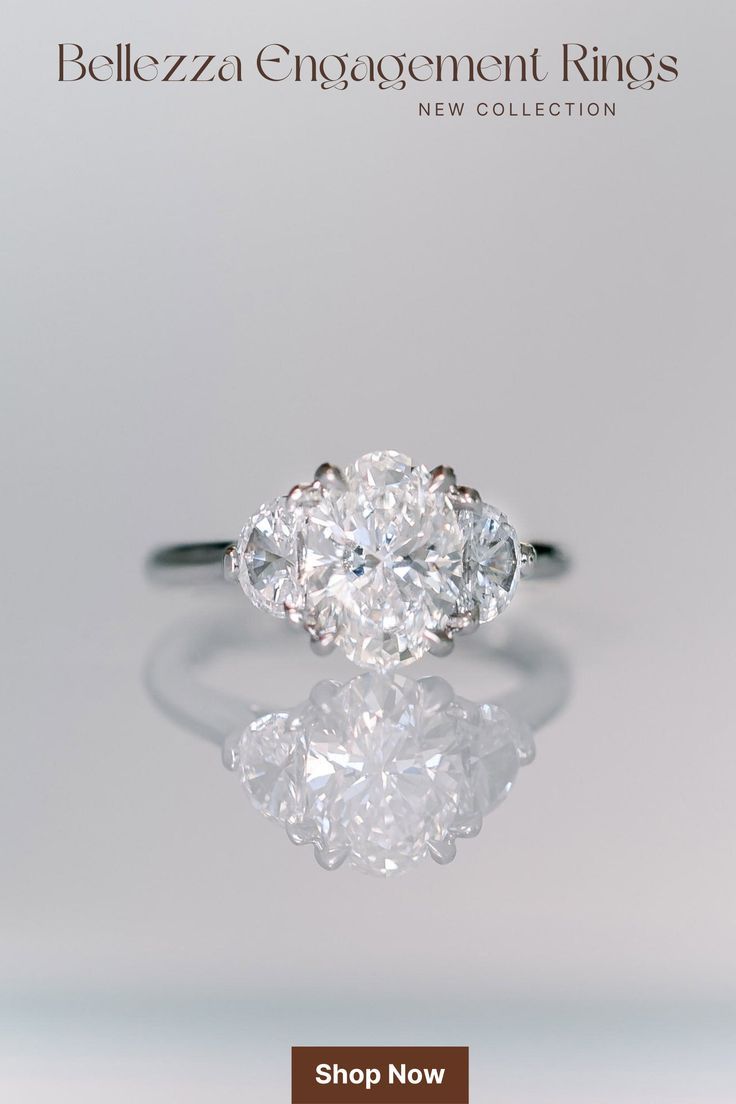 an oval diamond ring on a reflective surface