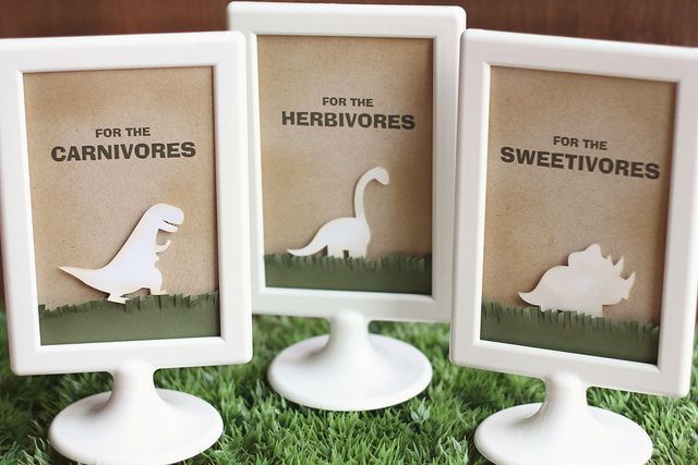 three small white frames with the words for the herbvores and an image of a dinosaur