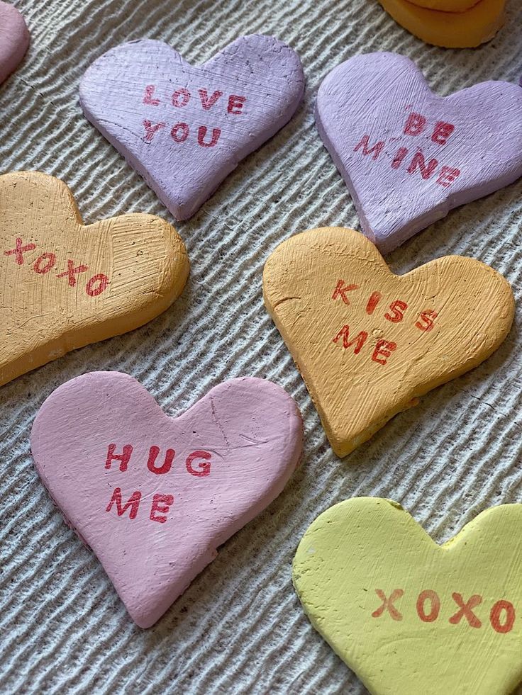 heart shaped cookies with words written on them