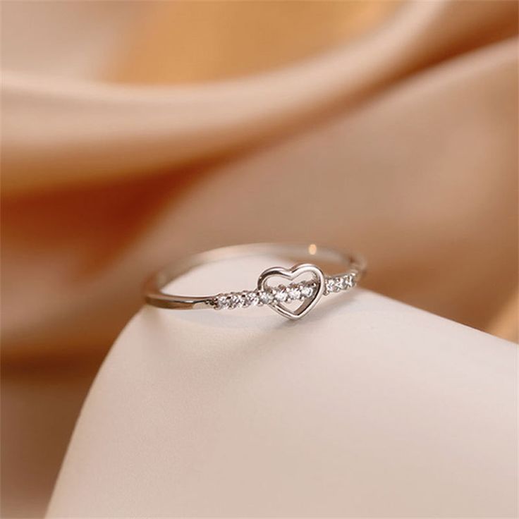 Description & Details A symbol of love that captures the essence of heartfelt connections. Each piece in our collection is meticulously crafted to showcase the timeless beauty of the heart shape, making a meaningful statement of affection and emotion.• Material: Solid 925 Sterling Silver ∙ Cubic Zirconial• Finish: Hypoallergenic ∙ Gold Plating• Dimensions: US size 4 3/4 - 6 1/2 available• All our work is custom made by hand with love Slim Ring, Symbol Of Love, Love Symbols, Silver Heart, Heart Shape, Solid 925 Sterling Silver, Gold Plating, Timeless Beauty, Of Love