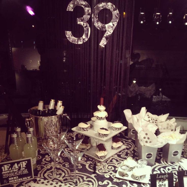 a table topped with cupcakes and wine glasses