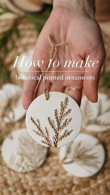 a hand holding a white ornament with a plant on it and the words how to make botanical printed ornaments