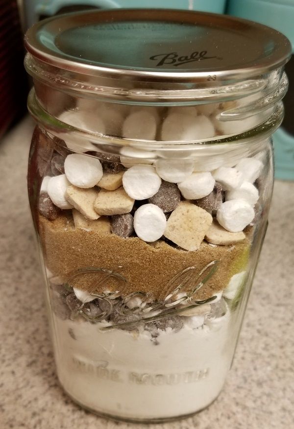 a jar filled with marshmallows and other things