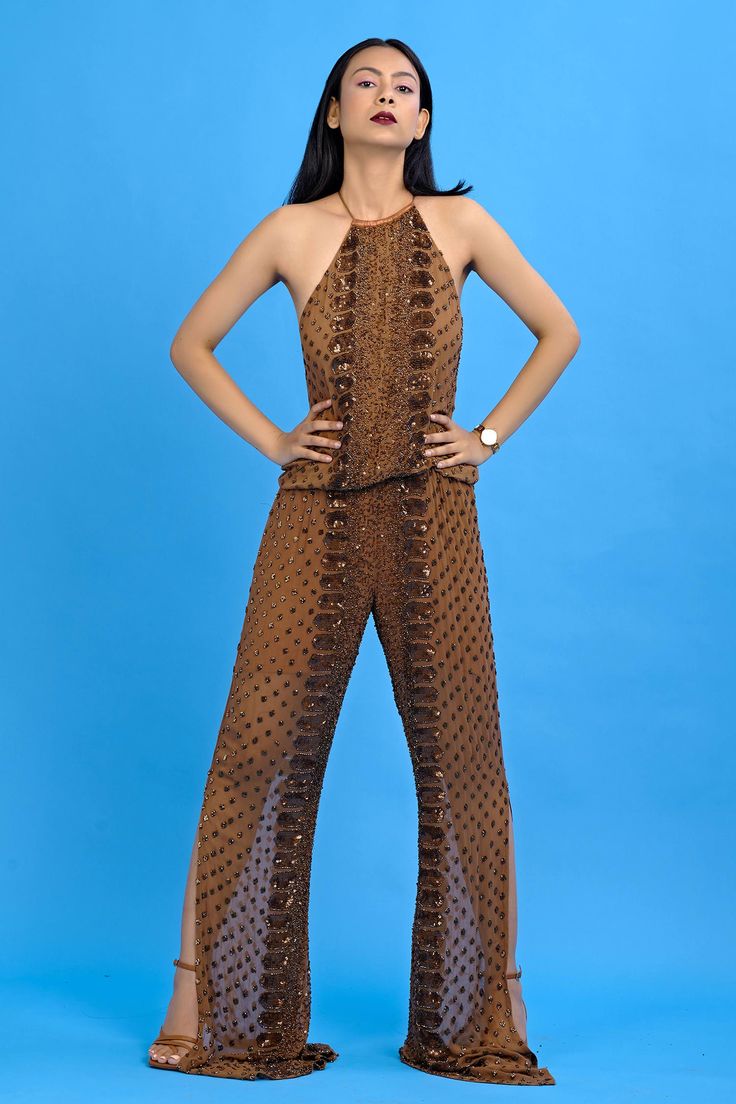 Brown embroidered halter neck jumpsuit with side slits and cutout back.
Components:1
Embroidered
Neckline:Halter neck
Sleeve Length:Sleeveless
Color:Brown
All over sequins embroidery
Side slits jumpsuit - Aza Fashions Brown Embroidery, Brown Jumpsuits, Embroidered Jumpsuit, Halter Neck Jumpsuit, Jumpsuit For Women, Jumpsuit Online, Embroidered Neckline, Fashion App, Sequins Embroidery