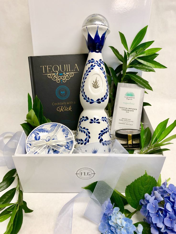 a blue and white vase sitting next to a box with items in it on a table