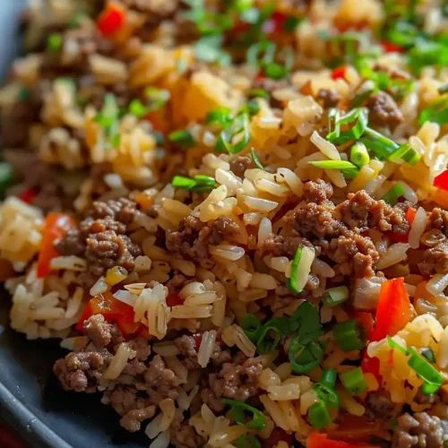 a plate full of rice and meat with green onions on the side is ready to be eaten