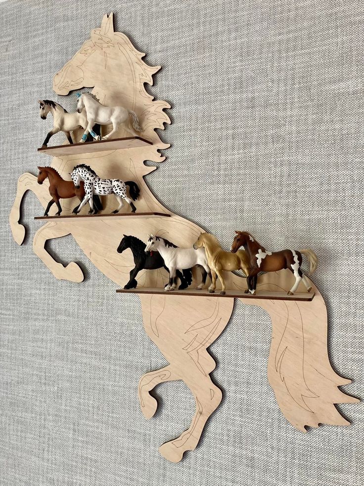 a wooden horse shelf with horses on it