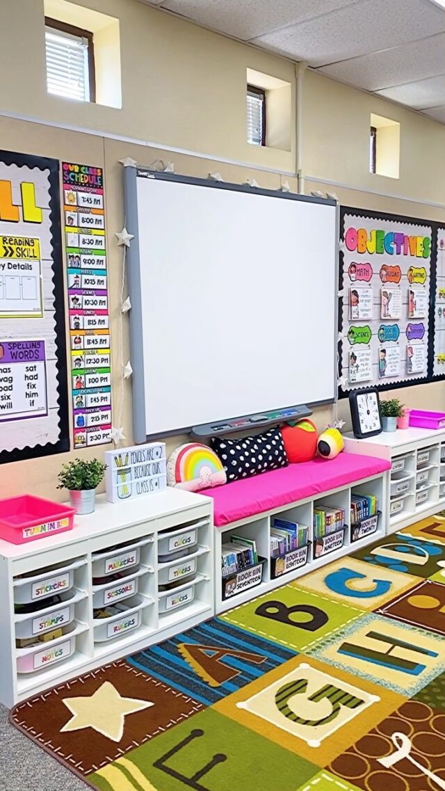 an empty classroom with colorful rugs and whiteboard on the wall in front of it