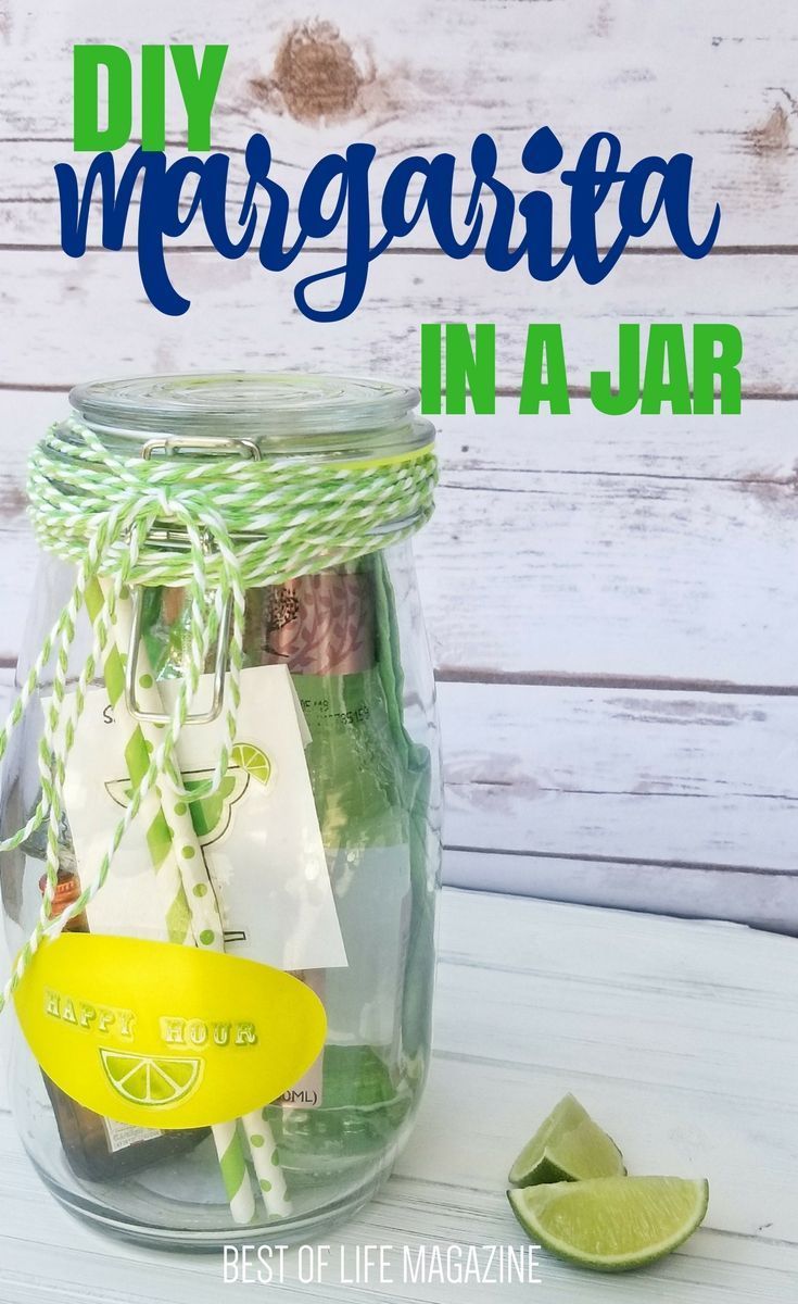 a mason jar filled with limes, lemon wedges and paper tags that read diy margarita in a jar