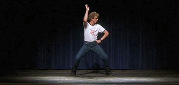 a man standing on top of a stage holding a frisbee in his hand