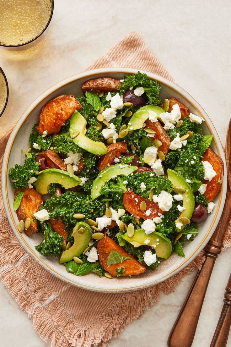 a salad with broccoli, feta cheese and olives in a bowl