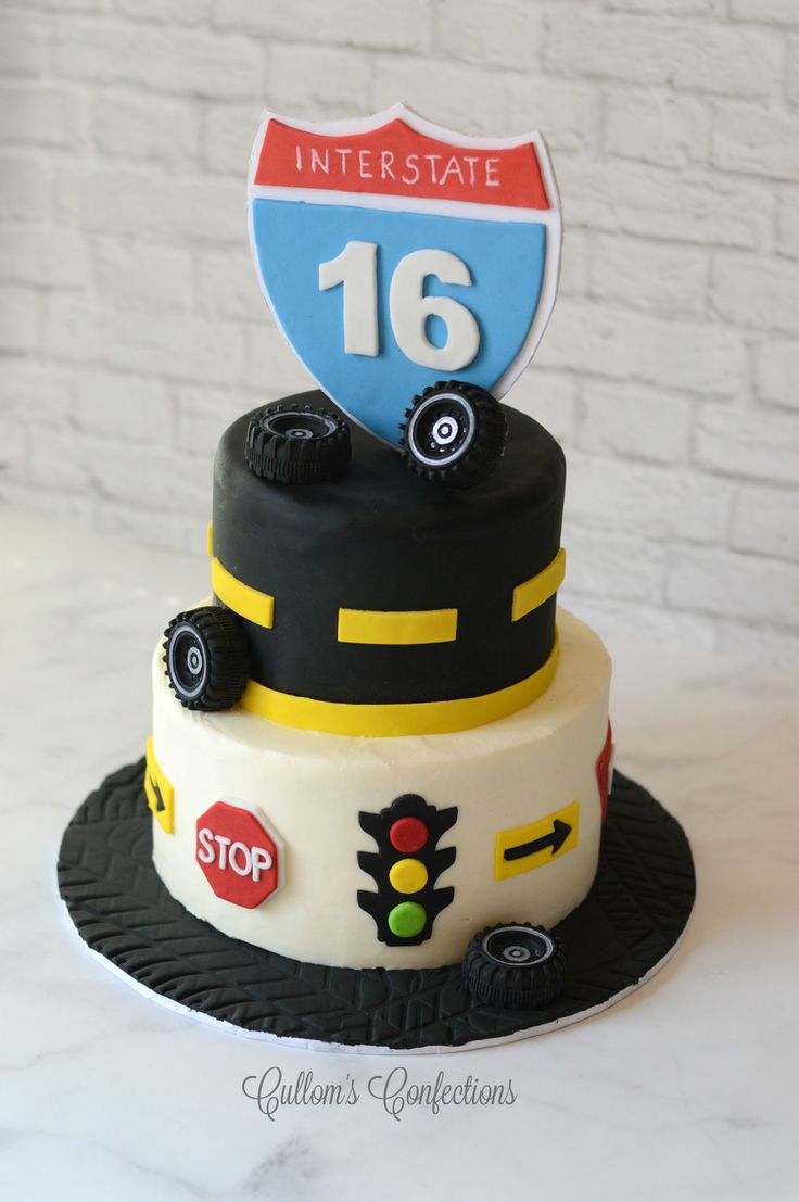 a cake that is decorated to look like a race car with the number sixteen on top