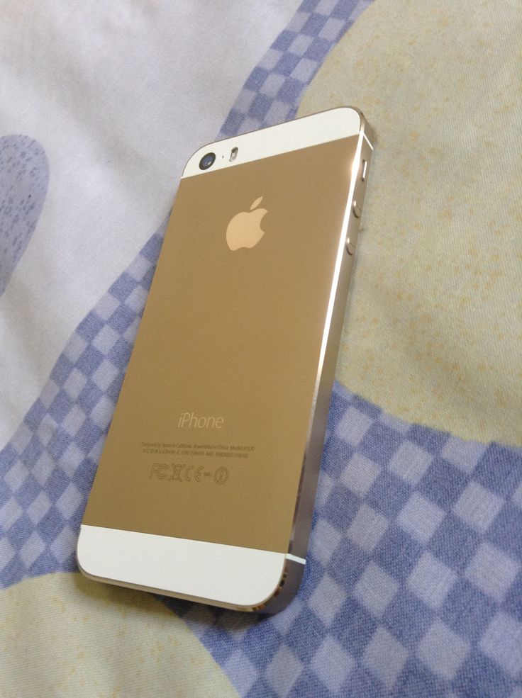 an iphone sitting on top of a blue and white checkered blanket