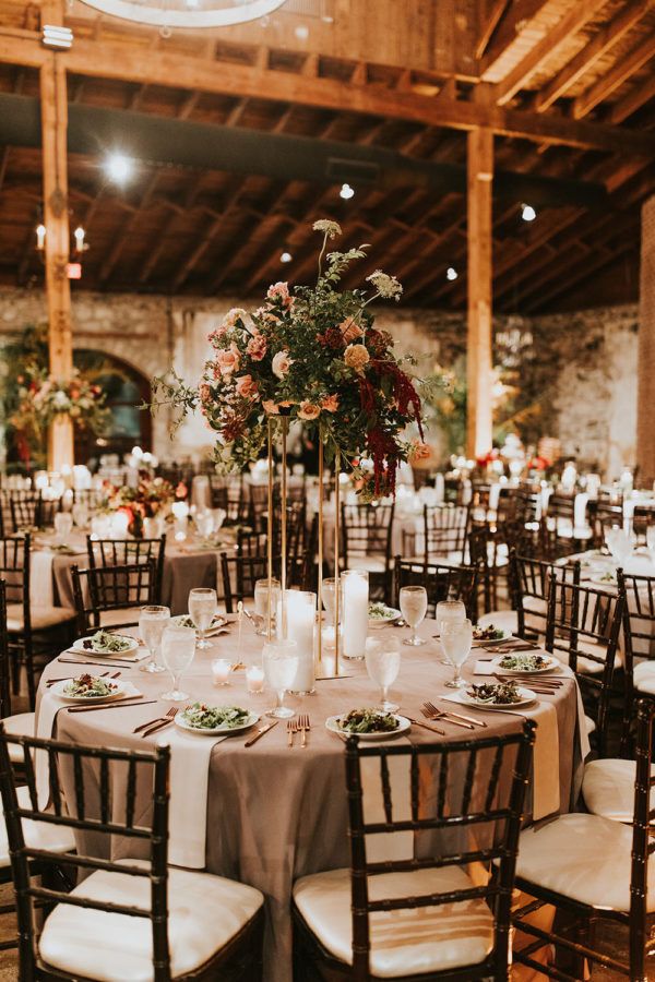 the tables are set up with candles and centerpieces for an elegant wedding reception