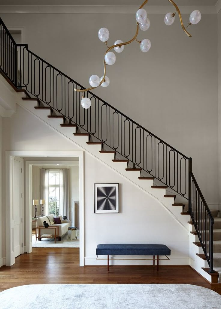 a living room filled with furniture and a stair case