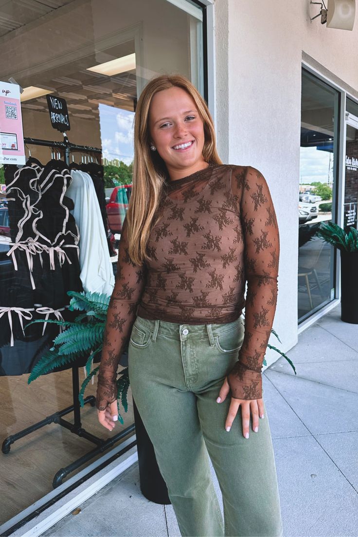 Sheer, lace, long-sleeve top. This edgy and feminine shirt is perfect for layering throughout the seasons. Wear on its own with a tank top or bandeau underneath. Made from a soft and stretchy material that is extremely lightweight. Features thumb holes for an urban inspired look. Outfit inspo: Great to wear under a graphic tee or dress, casually, or to a concert or festival. Ella-Morgan is seen wearing a size medium. 90% nylon, 10% spandex. Feminine Shirts, The Seasons, Thumb Holes, Sweater Coats, Sheer Lace, Skirt Pants, Tee Shop, Stretchy Material, Dress Accessories