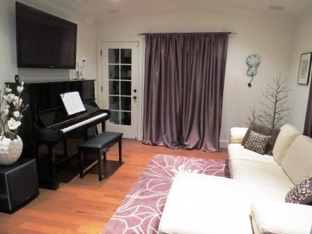 a living room filled with furniture and a piano