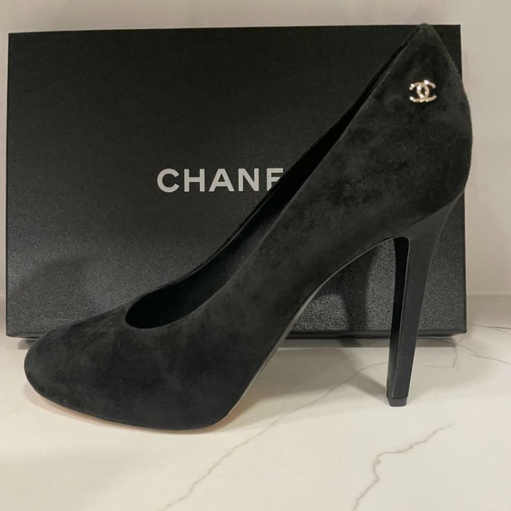 Chanel 18c Collection These Black Suede Round Toe Pumps Feature A Hidden 0.25" Platform, A 4.5" Satin Covered Slim Heel. Goldtone Cc Logo On The Sides. Padded Leather Insole And Leather Sole. Made In Italy. Size: 41 Eu (Insole Measures 10.5"). Typically Chanel Shoes Run Small. Brand New In Chanel Box. Chanel Shoes Heels, Chanel Pumps, Chanel Heels, Fancy Heels, Chanel Box, Vintage Heels, Round Toe Pumps, Satin Heels, Black Suede Heels