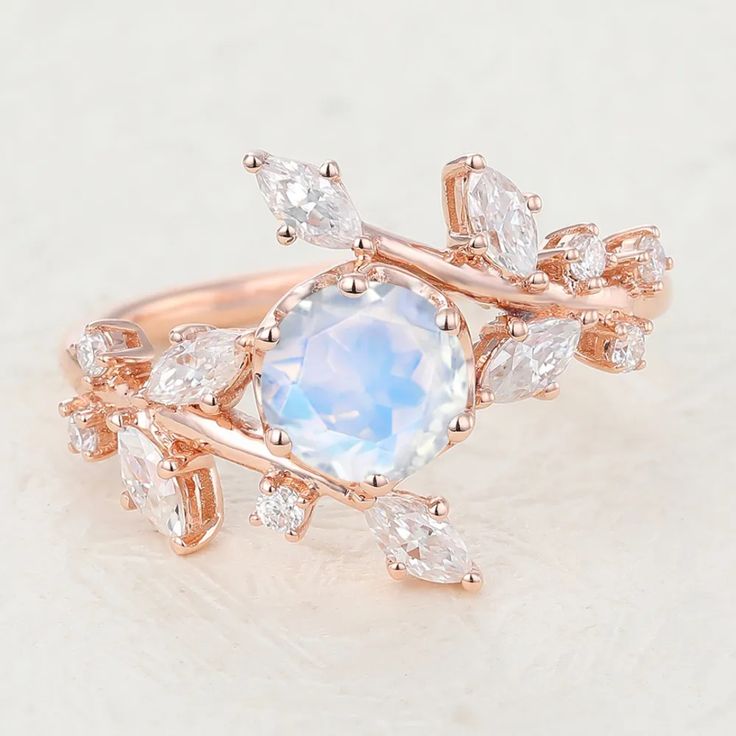 a rose gold ring with an oval blue topazte surrounded by white diamonds