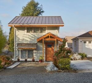 a house with a metal roof and two garages