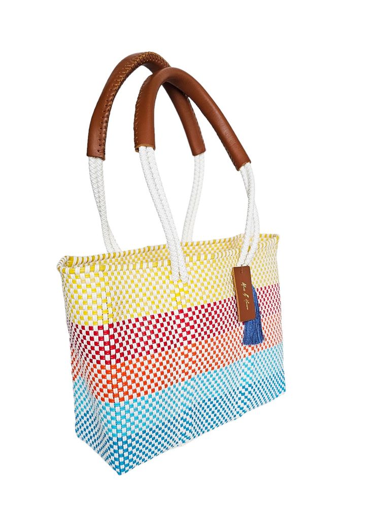 Introducing the Mini-Sunrise Beach Tote Bag - a must-have accessory for beach lovers! Made by hand for exceptional quality and durability, this trendy tote is perfect for carrying all your beach essentials. Say goodbye to boring bags and hello to a sunny day by the sea! Details & Dimensions Unlined Durable leather top handles Fits a 16" laptop 15" W (38cm) x 13" H (33cm) Top Handles Drop 7" (17.7cm) Shopping Beach Bag With Braided Top Handles, Shopping Beach Bag With Top Handle And Braided Handles, Top Handle Beach Bag With Braided Handles For Shopping, Multicolor Straw Bag For Beach Travel, Multicolor Straw Bag For Beach Season Travel, Multicolor Straw Bag For Travel And Beach Season, Multicolor Summer Bucket Bag For Travel, Coastal Rectangular Bag For Daily Use, Coastal Style Tote Bag For Daily Use