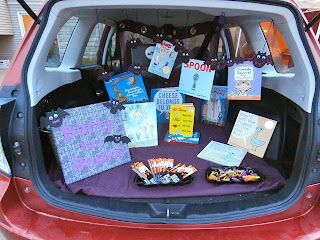 the trunk of a car is filled with books and cards