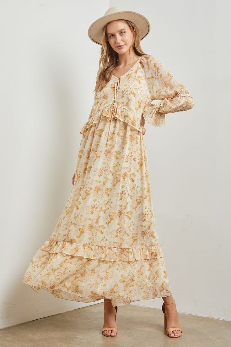 This Stella Floral Long Sleeve Maxi Dress features a stunning floral print and ruffle trim for a boho chic look. Made with chiffon flowy fabric, it offers a relaxed fit and long sleeves for added comfort. Elevate your style with this must-have dress. floral print long sleeves lined ruffle trim v-neckline 100% polyester model is wearing a small Spring Floral Dress With Ruffle Sleeves, Flowy Floral Dress With Ruffle Sleeves For Spring, Billowy Long Sleeve Floral Maxi Dress, Bohemian Floral Maxi Dress For Fall, Bohemian Style Floral Maxi Dress For Fall, Casual Flowy Tiered Boho Dress, Floral Print Maxi Dress With Ruffle Sleeves For Vacation, Long Sleeve Maxi Dress With Floral Print, Chiffon Maxi Dress With Floral Print And Long Sleeves