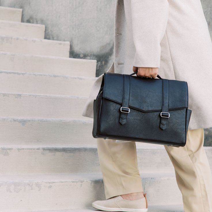 a person carrying a briefcase down some steps