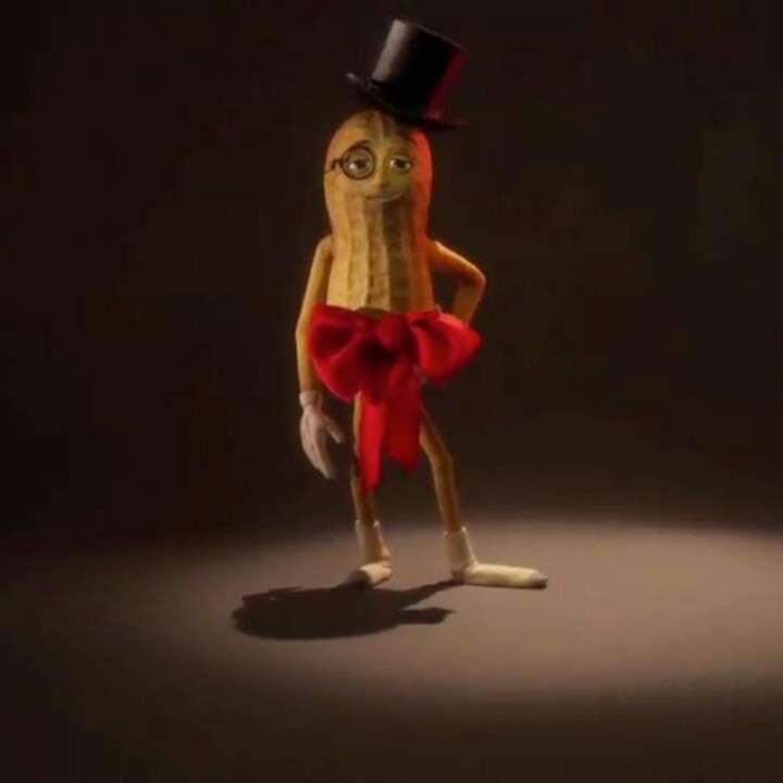 a banana wearing a top hat and red bowtie standing in front of a black background