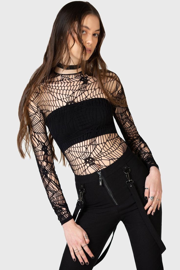 WEBS GRASP.- Soft, stretch fishnet.- Statement web style net with interwoven skulls.- Long sleeves.- Fitted.With KIHILIST branding, 94% Polyamide, 6% Elastane.Hand wash cold (30°c) / Do not bleach / Do not tumble dry / Iron at low temperature / Do not dry clean. Imported. Black Stretch Gothic Mesh Top, Stretch Mesh Top With Open Knit, Fitted Mesh Top With Hollow Out Details, Stretch Open Knit Mesh Top, Party Mesh Top With Hollow Out Detail, Gothic Black Stretch Mesh Top, Party Mesh Top With Hollow-out Details, Black Gothic Mesh Top For Night Out, Edgy Mesh Top For Parties