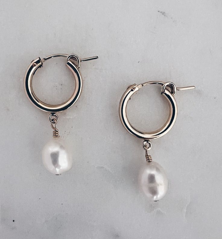 Pretty white & shimmery baroque pearls are hand wired onto 14k gold filled huggie hoops. Hoop is about 14mm and total length is about 1.25 inches. Safe for sensitive skin Tarnish Proof Teardrop Huggie Earrings With Pearl Charm, Everyday Hoop Earrings With Pearl Charm, Everyday Teardrop Huggie Earrings With Pearl Drop, Hypoallergenic Pearl Teardrop Hoop Earrings, Hypoallergenic Teardrop Pearl Hoop Earrings, Hypoallergenic Huggie Pearl Earrings, Pearl Charm Huggie Earrings, White Pearl Drop Hoop Earrings In 14k Gold, Round Hoop Earrings With Baroque Pearl Drop