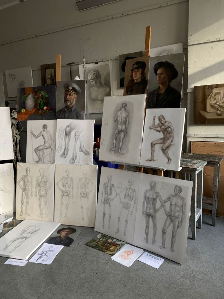 several drawings are on display in an art studio