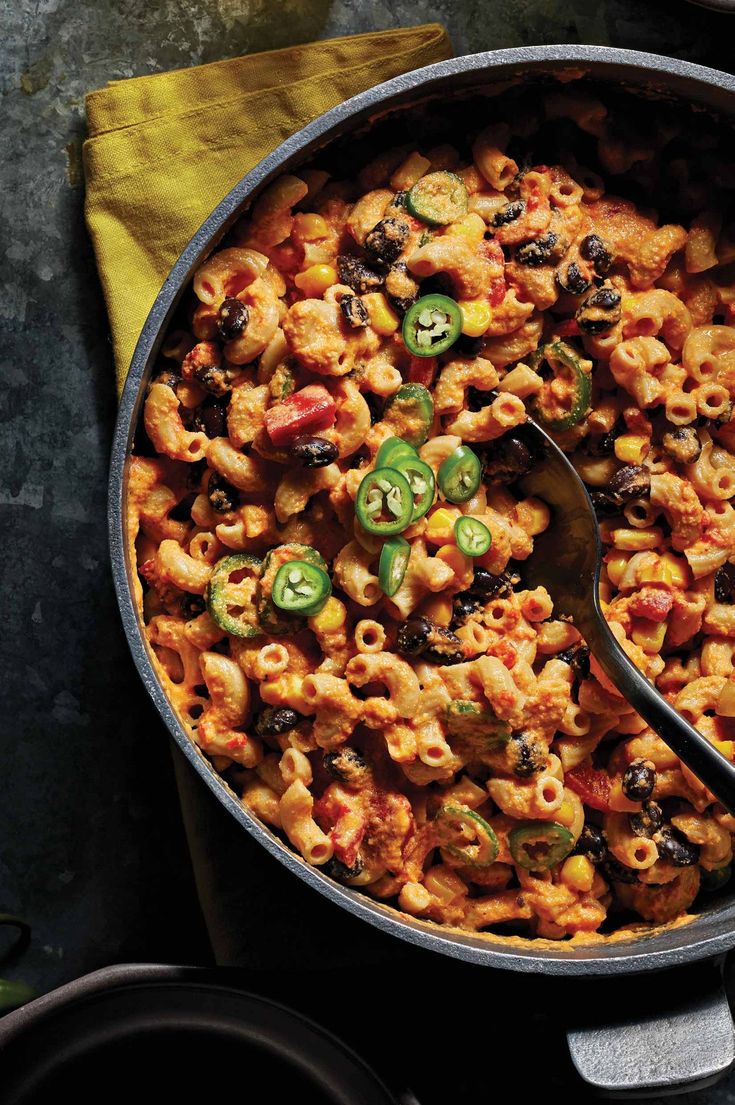 a skillet filled with pasta and vegetables