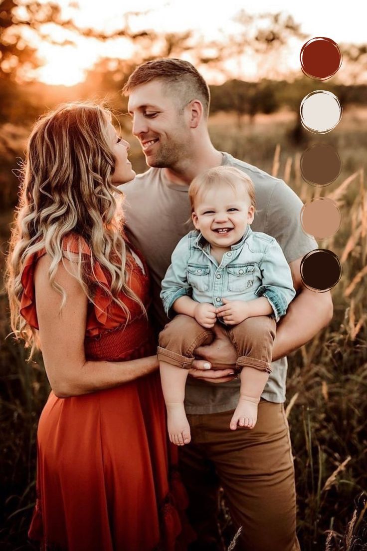 a man and woman holding a baby while standing in tall grass with circles above them